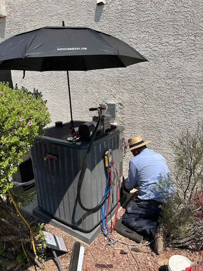 HVAC technician performing outdoor AC maintenance in Bourbonnais